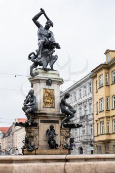 Travel to Germany - view of Herkulesbrunnen (Hercules fountain) on Maximilianstrasse street in Augsburg city in rainy spring day
