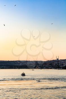 Travel to Turkey - boats in Golden Horn bay in Istanbul city in spring evening