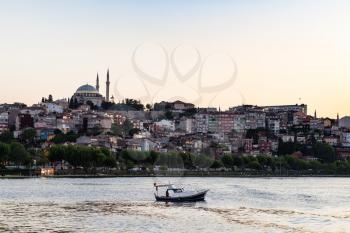 Travel to Turkey - view of Fatih quarter in Istanbul city in spring evening from Golden Horn bay