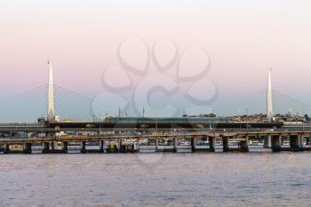Travel to Turkey - view of Golden Horn Metro Bridge in Istanbul city in spring evening