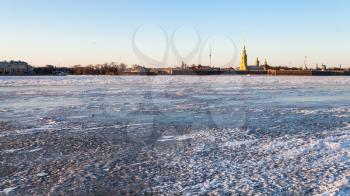 panoramic view of frozen Neva river and Peter and Paul Fortress in Saint Petersburg city in March evening