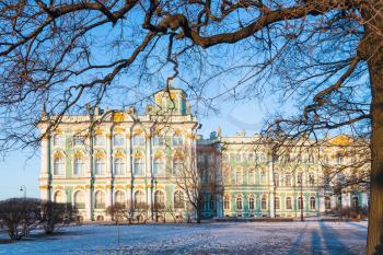 side view of Winter Palace from Gardens of the Winter Palace in Saint Petersburg city in March evening