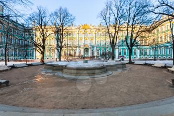 view of Winter Palace from Gardens of the Winter Palace in Saint Petersburg city in March evening