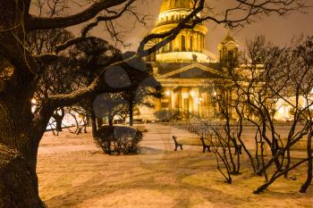 snow-covered garden near Saint Isaac's Cathedral on St Isaac Square in Saint Petersburg city in night snowfall