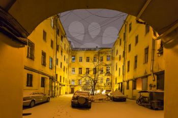 view of urban courtyard in St Petersburg city in night snowfall