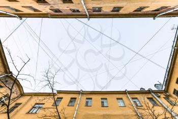 bottom view of many electrical wires and cables over urban yard in Saint Petersburg city in Saint Petersburg city in spring morning