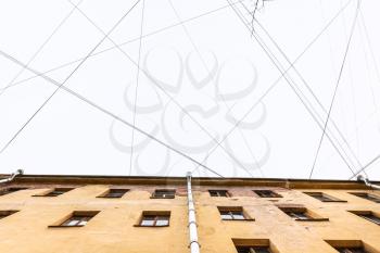 bottom view of many electrical wires and cables over urban house in Saint Petersburg city in Saint Petersburg city in spring morning