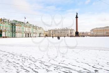 view of snow-coverd Palace Square with Alexander Column and Winter Palace in Saint Petersburg city in morning