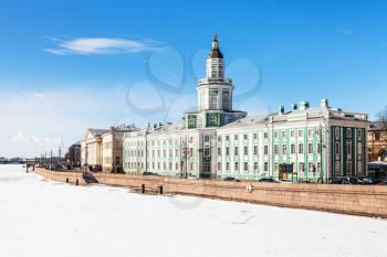 view of Universitetskaya Embankment with Kunstkamera and Academy of Sciences building on Vasilievsky Island in St Petersburg city from the Palace Bridge in sunny spring day