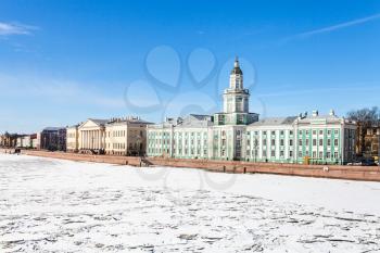 view of Universitetskaya Quay with Kunstkamera and Academy of Sciences buildings on Vasilievsky Island in St Petersburg city from the Palace Bridge in sunny march day