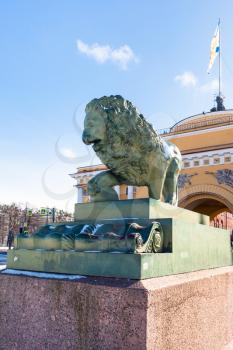 bronze statue of Guard lion and old Admiralty building on Admiralty Embankment in Saint Petersburg city in march