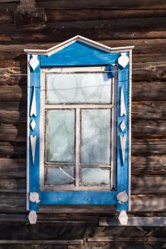 frozen window in old wooden typical russian rural house in winter in little village in Smolensk region of Russia