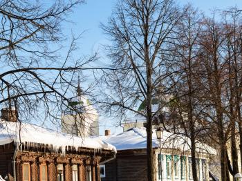 old urban wooden houses on street in Suzdal town in winter in Vladimir oblast of Russia
