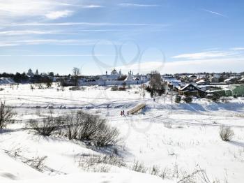 view of Pokrovskiy Monastery (Convent of the Intercession) on riverbank of frozen river in Suzdal town in winter in Vladimir oblast of Russia
