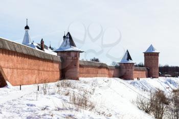 walls of Monastery of Our Savior and St Euthymius in Suzdal town on riverbank of frozen river in winter in Vladimir oblast of Russia