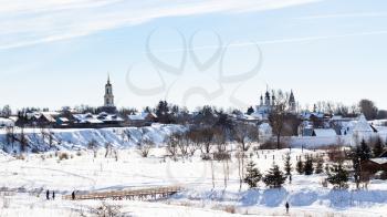 panorama of Suzdal town with Prepodobenskay bell tower in Monastery of Deposition of the Robe, Church of the Ascension in Alexandrovsky Convent and walls of Convent of the Intercession in winter