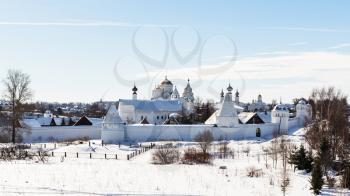 panoramic view of Convent of the Intercession (Pokrovskiy Monastery) on riverbank of frozen river in Suzdal town in winter in Vladimir oblast of Russia