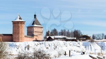 people near Passage Tower of Monastery of Our Savior and St Euthymius in Suzdal town in winter in Vladimir oblast of Russia
