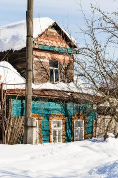 snow-covered old urban wooden house on street in Suzdal town in winter in Vladimir oblast of Russia