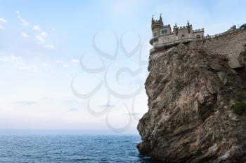 travel to Crimea - view of Swallow Nest Castle on Aurora Cliff of Ay Todor cape on Crimean South Coast of Black Sea on sunset