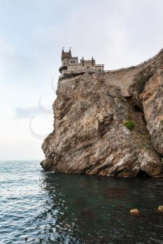 travel to Crimea - view of Swallow Nest Castle on Aurora Cliff of Ay Todor cape over Black Sea in evening