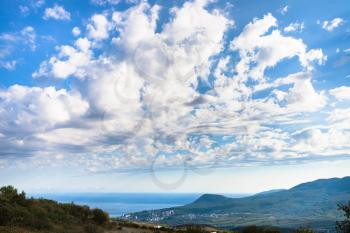 travel to Crimea - white clouds in blue afternoon sky over Alushta city on coast of Black sea in september