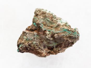 macro shooting of natural mineral rock specimen - raw Malachite (copper ore) stone on white marble background