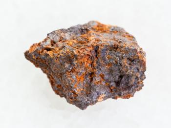 macro shooting of natural mineral rock specimen - Hematite (iron ore) stone on white marble background
