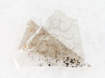 macro shooting of natural mineral rock specimen - raw muscovite mica lamina on white marble background