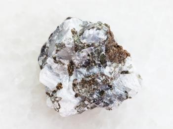 macro shooting of natural mineral rock specimen - rough sphalerite (zinc blende) stone on white marble background