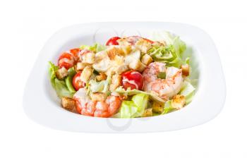 Caesar salad with prawns on white plate isolated on white background