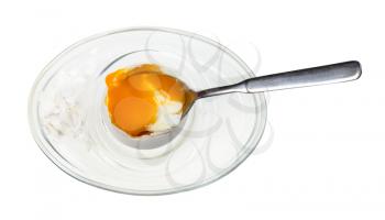 top view of eating of soft-boiled egg with spoon in glass egg cup isolated on white background