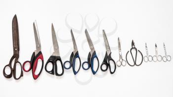 top view of line from various scissors on white background