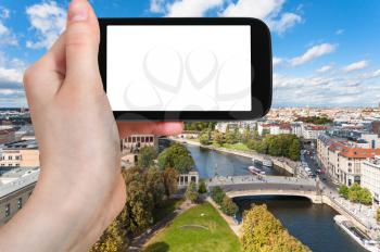 travel concept - tourist photographs Berlin cityscape with Museums at Museumsinsel and Spree River in Germany in september on smartphone with cut out screen for advertising logo