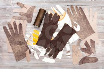 workshop on sewing gloves - top view of various objects for gloves production on wooden background