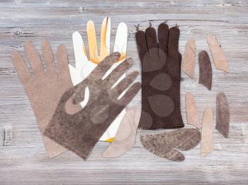 workshop on sewing gloves - top view of set of items for glove production on wooden background