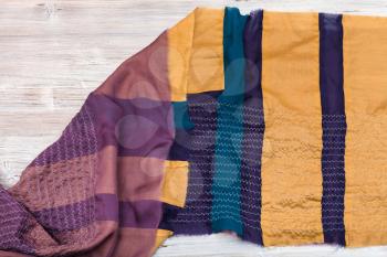 workshop on sewing a patchwork scarf - raw stitched silk shawl on table