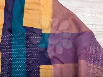 workshop on sewing a patchwork scarf - not hemmed stitched silk shawl on table