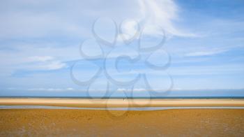 travel to France - blue sky over wet yellow sand beach Le Touquet (Le Touquet-Paris-Plage) on coast of English Channel