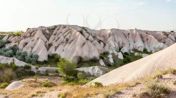 Travel to Turkey - little orchard on rock slope in Uchisar village in Cappadocia in spring
