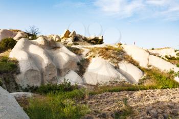 Travel to Turkey - garden between rock slopes in Uchisar village in Cappadocia in spring