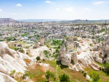 Travel to Turkey - above view of carved houses and Goreme town from mountain in Cappadocia in spring