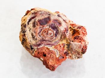 macro shooting of natural mineral rock specimen - raw Bauxite stone on white marble background