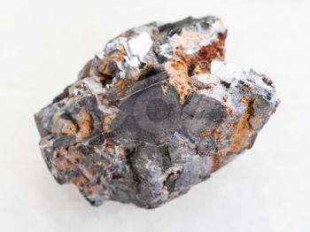macro shooting of natural mineral rock specimen - rough Galenite stone on white marble background