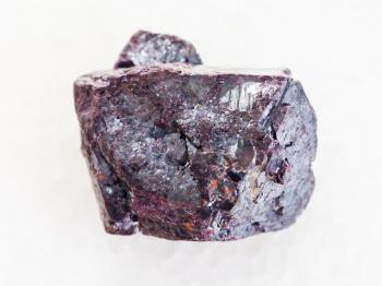macro shooting of natural mineral rock specimen - rough Cuprite stone on white marble background from Altai Mountains, Russia