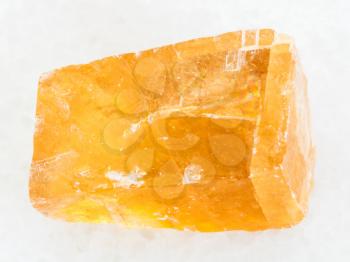 macro shooting of natural mineral rock specimen - raw tea Calcite stone on white marble background from Mexico