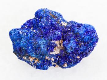 macro shooting of natural mineral rock specimen - rough crystalline Azurite stone on white marble background from Rubtsovskiy mine, Altai Mountains, Russia