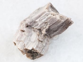 macro shooting of natural mineral rock specimen - piece of baryte stone on white marble background from Irkutsk region, Russia