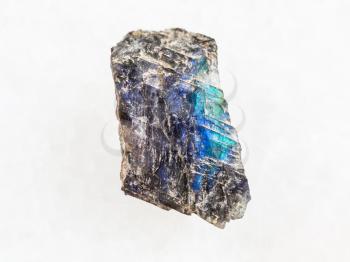 macro shooting of natural mineral rock specimen - labradorite stone on white marble background from Finland