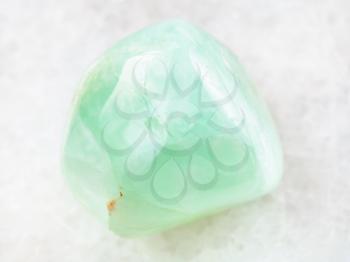 macro shooting of natural mineral rock specimen - Prehnite gemstone on white marble background from Republic of Mali